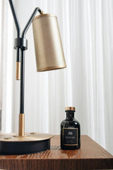 black glass bottle on brown wooden table