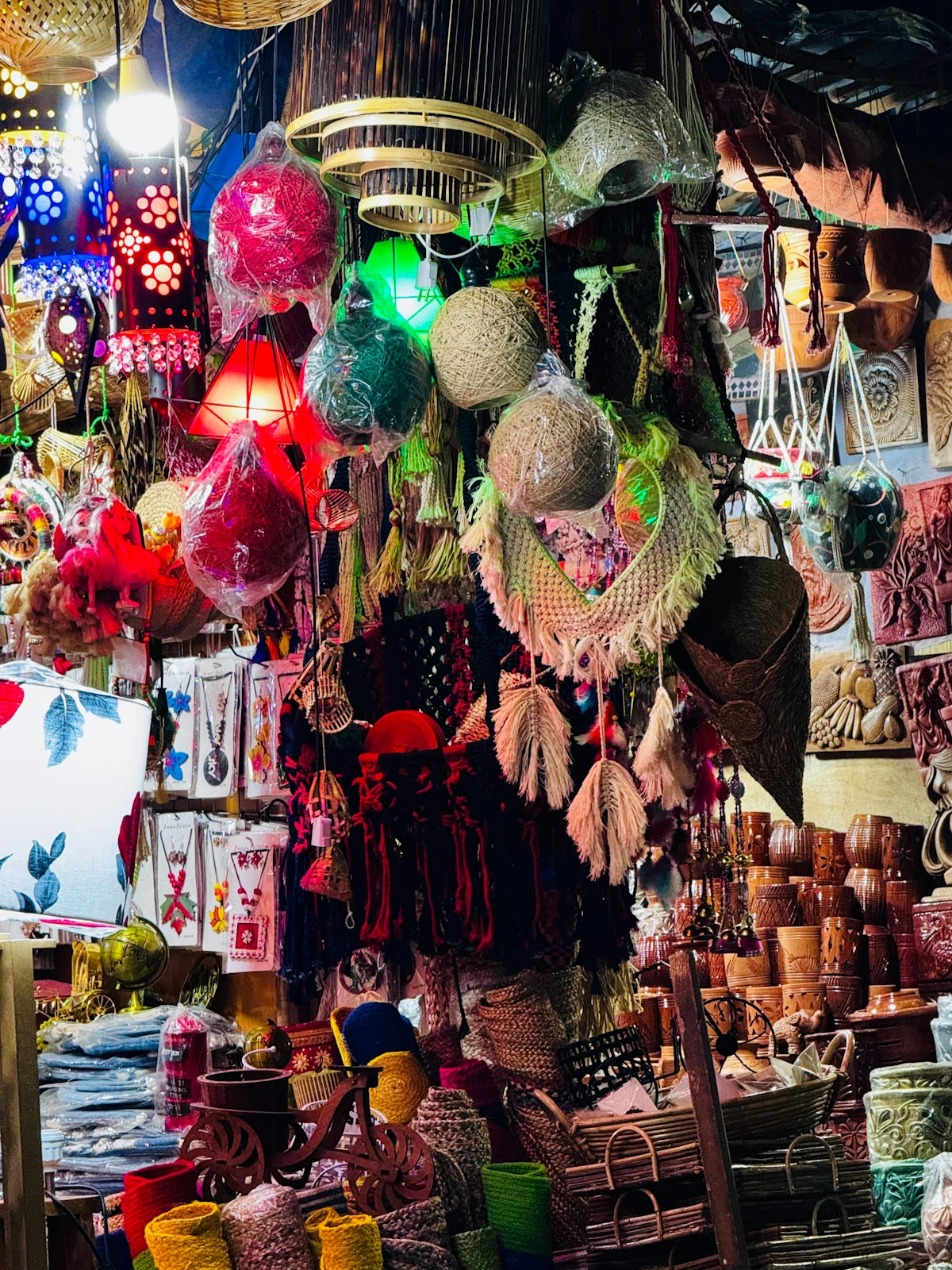 Colorful handmade crafts and lanterns displayed at market.