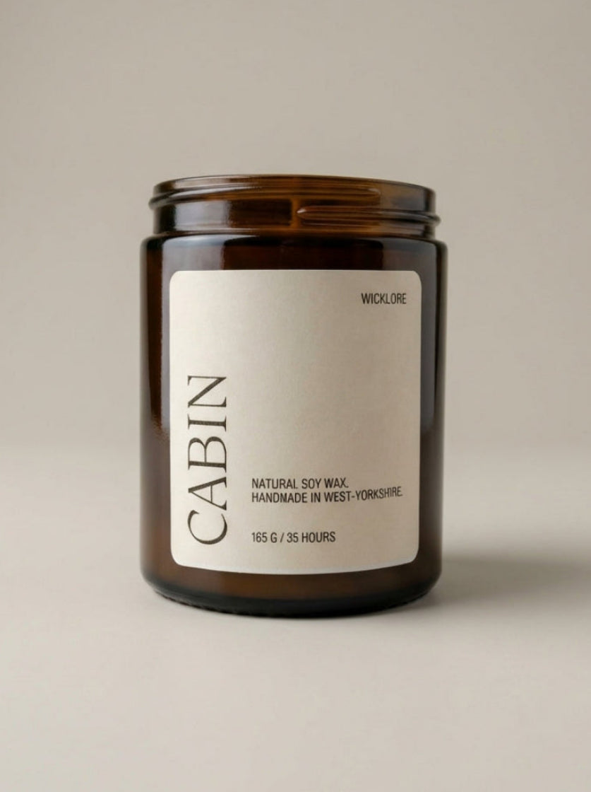 Candle jar labeled 'Cabin' on a beige background