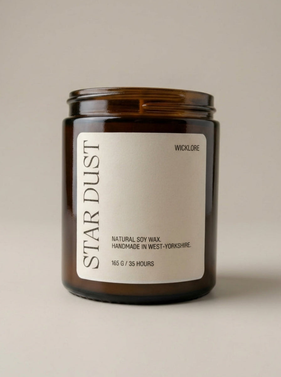 Candle with 'Star Dust' label on a beige background